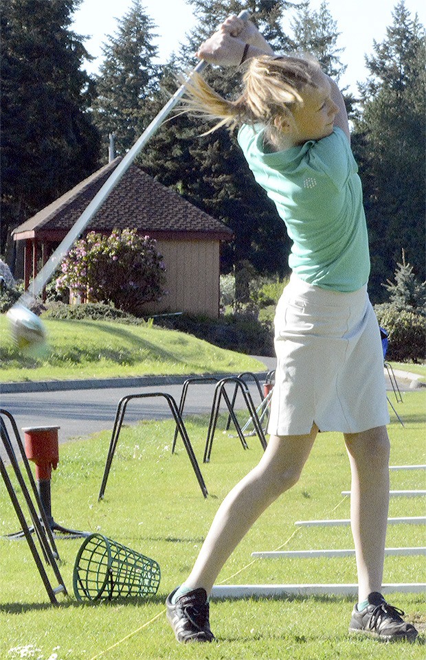 Malia Schroeder practices her drive at Kayak Point Country Club.