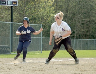 Arlington runner Lisa Allen keeps an eye on her batting teammate as she leads off from third base against Lake Stevens.