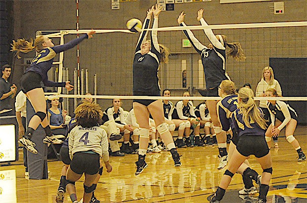 Arlington blocks a spike by Oak Harbor during their game.
