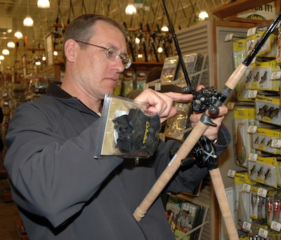 Mount Vernon's Richard Bender tests out the fishing reels at the Tulalip Cabela's on April 19.