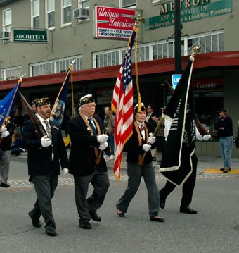 Members of Arlington American Legion Post 76 carry the colors representing the United States