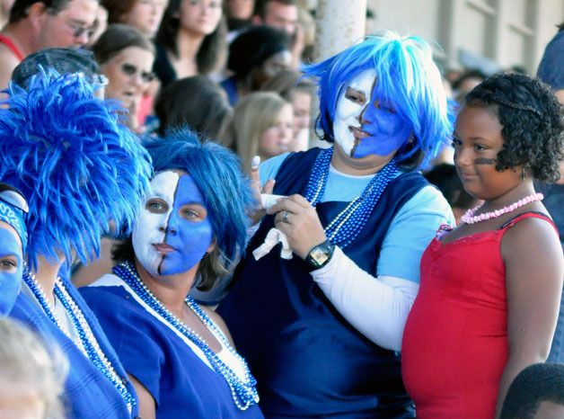 Hundreds of extras donning red and blue fill the stands at Haller Stadium in Arlington on Sunday