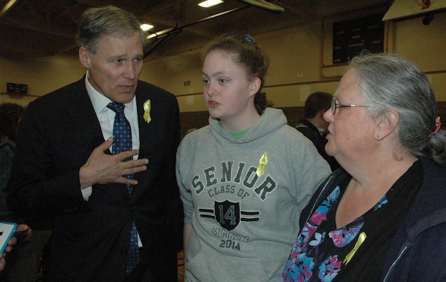 Gov. Jay Inslee chats with Kaitlyn Toomey and her mother Candy at Haller Middle School on April 4.