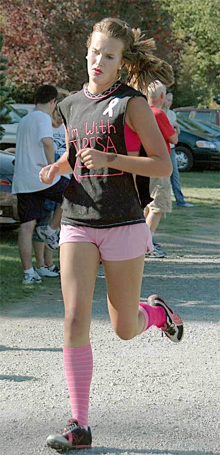 Arlington cross country teammate Lexi Sarver races to the finish line at River Meadows Park