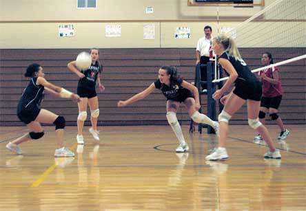 Sophomore right sider Jackie Reiser is there with a dig to back up middle blocker Esther Brown’s save attempt that bounces toward her teammate in the back row.