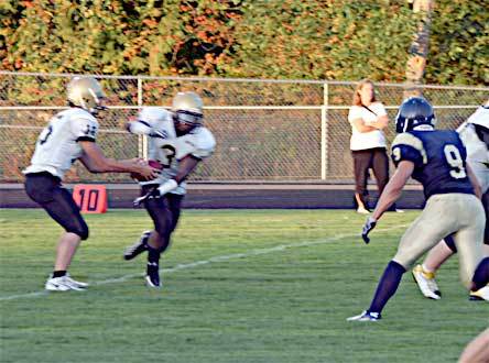 Arlington safety Jake Parduhn runs unimpeded toward the Lynnwood quarterback as he hands off the ball. The Arlington defense held Lynnwood scoreless in the Eagles’ home opener Sept. 11. Arlington won 61-0.