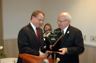 Steve Peiffle accepts the Arlington-Smokey Point Chamber of Commerce Citizen of the Year Award from George Boulton