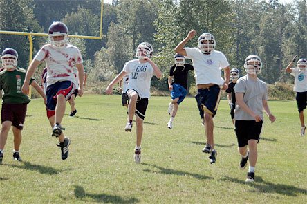 The Cougar football team warms up. From left