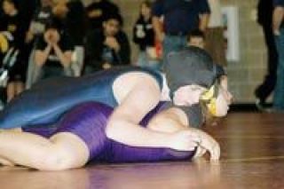Senior Lady Eagle wrestler Jennifer Jayne gives her opponent Natasha Grow of Lake Stevens a bloody nose Saturday
