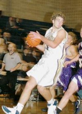 Senior center Abe Bourasaw looks to pass to an open teammate Wednesday