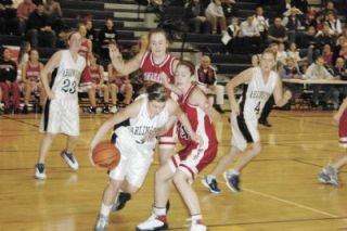 Kyra Prause weaves between defenders in the Tomahawks press. Prause finished with 17 points and 12 rebounds.