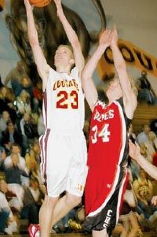 LHS senior forward Dan Spencer soars to the hoop against a Coupeville defender Wednesday