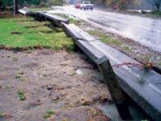 Floodwaters knocked aside the heavy concrete barriers on the side of Highway 530 adjoining Twin Rivers Park