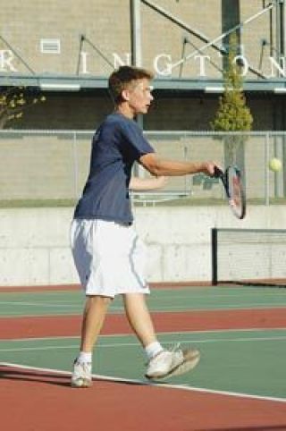 Junior Austen Davis returns a shot against No. 4 singles opponent Nick Hovde of Stanwood Wednesday