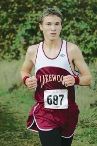 Freshman Chad Skiles treks through the trails portion of the Hole in the Wall 5K course Saturday