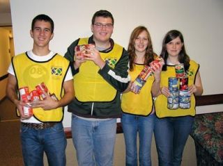 Members of the Mormon Church will be scouring neighborhoods on Oct. 27 to collect food donations for three local food banks. From left are Derek Warby of Arlington
