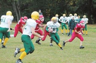 Sophomore quarterback Johnny Loughnan breaks through the M-P line on a keeper.