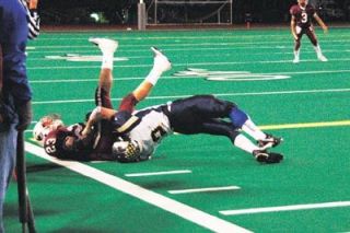 Junior defensive back Chris Myers tackles Cascade standout Julian Willis on the sideline