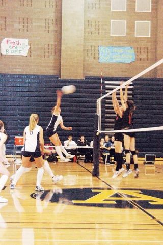 Arlingtons Ryanne Mueller smacks this kill down on the Monroe defense during the Eagles Oct. 18 match.