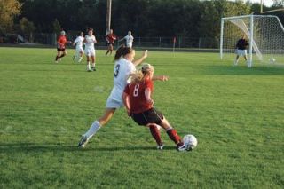 Stephanie Kushner gets her foot down to deflect a Murphy cross during their game Sept. 25.  Lakewoods defense was busy all evening against the Wildcats.