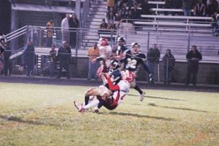 Junior defensive back Alex Marshman intercepts a ball intended for M-Ps Levi Cartas