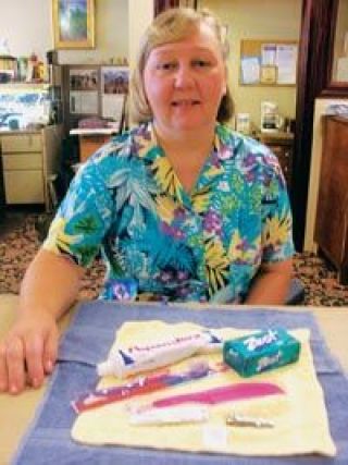 Eileen Oakes displays the contents of her health and hygiene kits for Lutheran World Relief