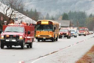 The Logger volleyball team received an escort on their return trip to Darrington from the state tournament .