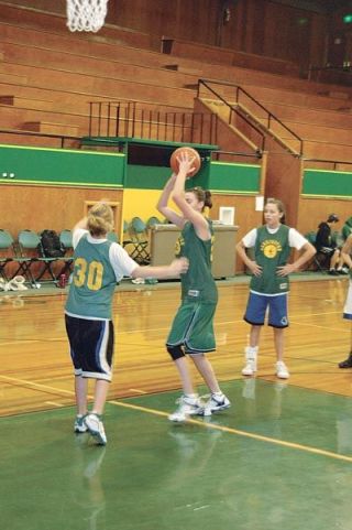 Kaitlyn Pendergrass swings the ball over her head during a rebounding drill at a Logger pre-season practice. Pendergrass will be one of only four seniors on a very young Logger team.