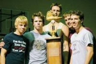 Members of both the Arlington and Lakewood wrestling squads stand next to the homemade cross town showdown trophy at LHS Thursday
