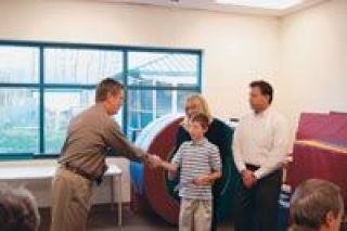 Karl Bielser of Arlington gets a check for $8