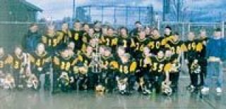 The Arlington Jr. Blue Eagles 11-12-year-old football team celebrates with their championship trophy.