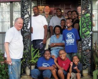 Mike Jones and Duane Weston meet the recipients of their efforts after a week of work at a home destroyed by the 2005 hurricane Katrina in Moss Point