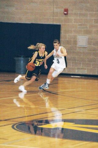 Kyra Prause slides her feet on defense during the Arlington Eagles 59-42 home loss to Everett.