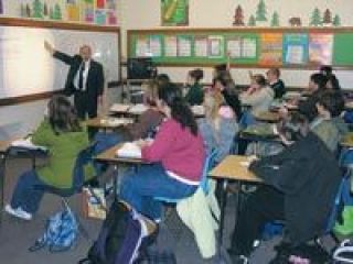 Masters Touch Christian School instructor Jim Underwood reviews a lesson with one of his seven classes of sixth- through eighth-grade students