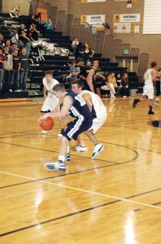 Point guard Will Heath applies full court pressure to the Meadowdale point guard during Arlingtons opening game of the season.