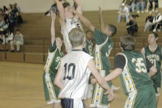 Bo Brummel negotiates the paint for a basket as Max Bryson looks on. Brummel scored two key baskets down the stretch in the fourth quarter as the Eagles held on to win.