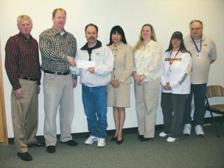 Representatives of the Stillaguamish Tribe of Indians give a $10