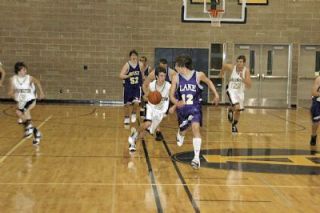 Will Heath leads the Arlington fastbreak during the third quarter of their 67-50 loss to Lake Stevens.