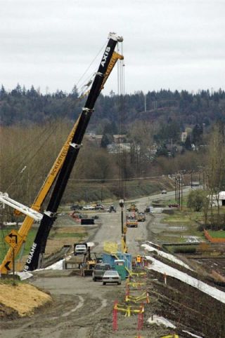 Two cranes are used March 17 to install two out of six girders on a new bridge that is part of the realignment of SR 9 north of Arlington. The second two girders were to be installed Tuesday