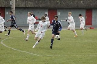 Sophomore midfielder Juan Guadarrama races Stanwoods Cale Kauffmann to the ball.