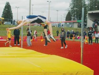 Arlington high jumper Brennan Cobb attempts a 5-8 high jump at Lake Stevens March 21.