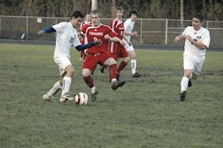 While M-P midfielder Nick Burdett dribbles the ball
