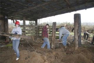 Arlington High School construction students and members of the Future Farmers of America team up to renovate a 93-foot by 23-foot shed to store the FFAs agricultural equipment.