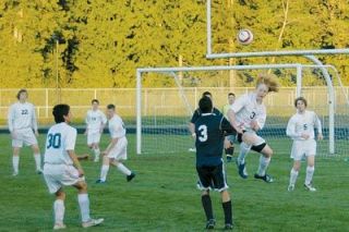 Left fullback Robert ODay displays his prowess in the air on a clearance.  ODay and the AHS defense left little room for Everett to attack.