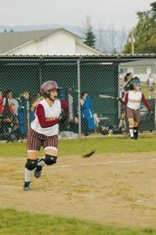 Becca Bean races to first base on a run-scoring single. Bean had three hits on the night.