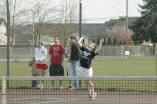 Morgan Galusha prepares to serve in her first doubles match against M-Ps April Bobadilla and Kelsey Brubaker. Galusha and doubles teammate Bridgette Burkholder won in a tiebreaker set.