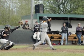 Arlington senior Cameron Hanson judges a pitch unhittable and holds his bat at the last second.