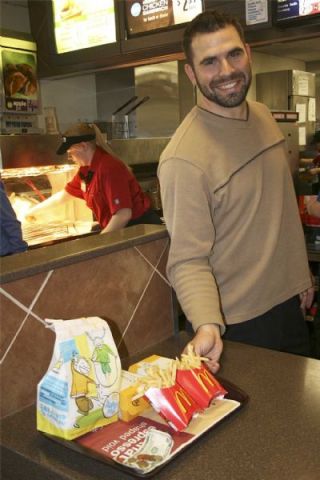 Arlington High School football coach Greg Dailer smiles as he served up customers orders.