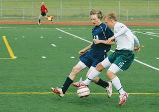 Garrett Meyer runs stride for stride with a Shoreline forward.  Meyer and the defense were tested all game long by the powerful Shorline attack