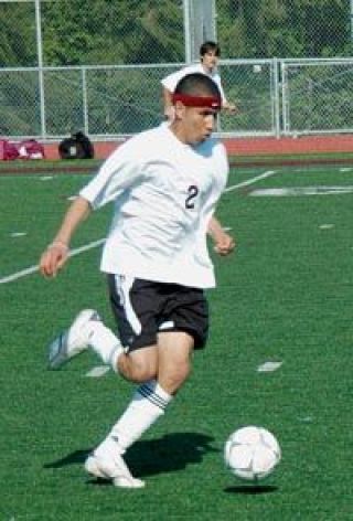 Andrew Escalante pushes the ball forward into the offensive end for Lakewood during their May 10 match with Archbishop Murphy.